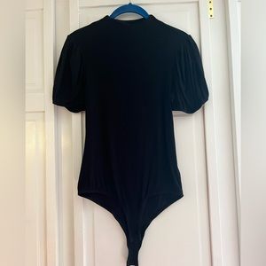 Black rib knit bodysuit with short puffy sleeves. Size S